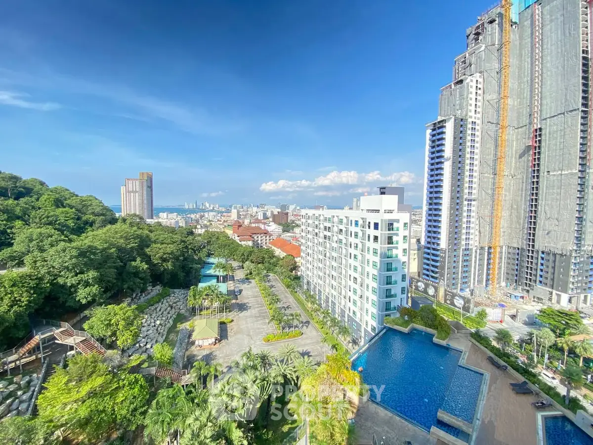 Stunning high-rise view with pool and lush greenery in urban setting