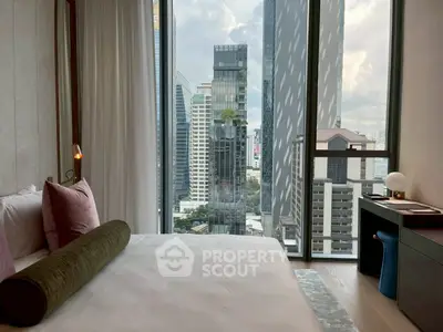 Luxurious bedroom with stunning city view from floor-to-ceiling windows in modern high-rise.