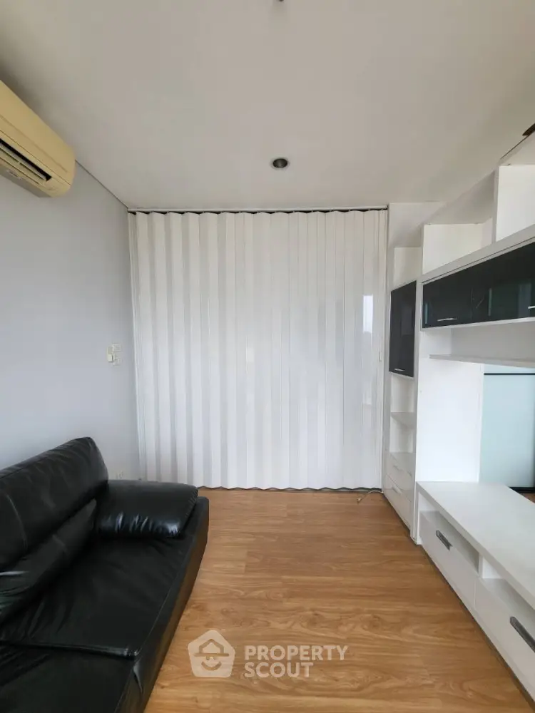 Modern living room with sleek leather sofa and stylish partition wall