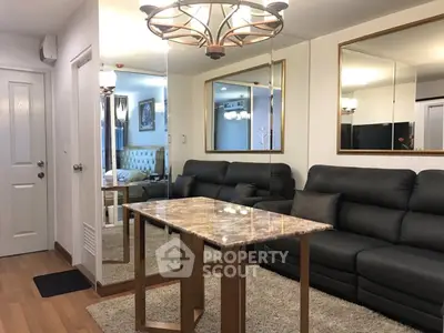 Elegant living room with modern chandelier and luxurious leather sofa