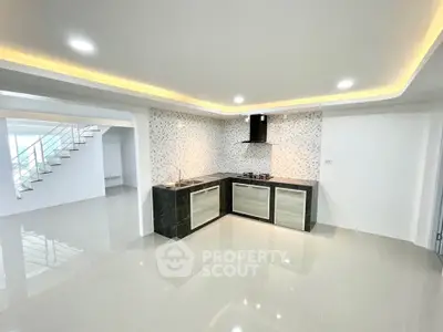 Modern open kitchen with sleek design and recessed lighting