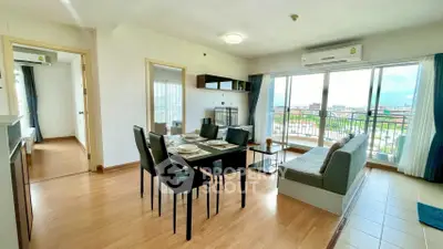 Spacious living room with dining area and balcony view in modern apartment