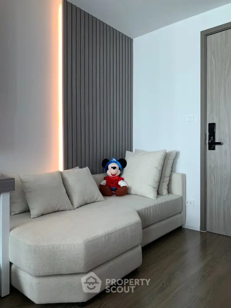 Modern living room with stylish sofa and accent lighting
