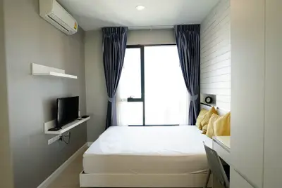 Modern bedroom with large window and minimalist decor