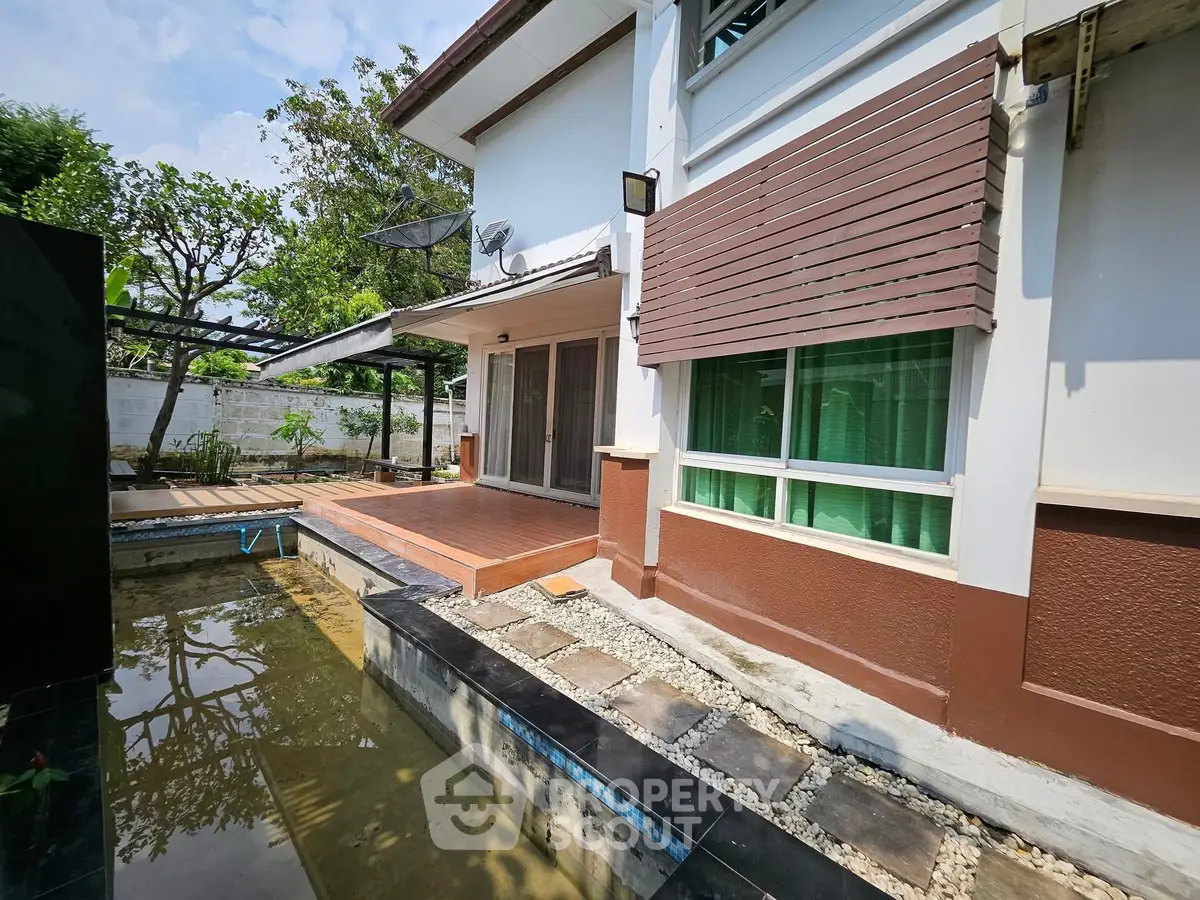 Charming residential exterior with patio and garden pond, perfect for relaxation and outdoor enjoyment.