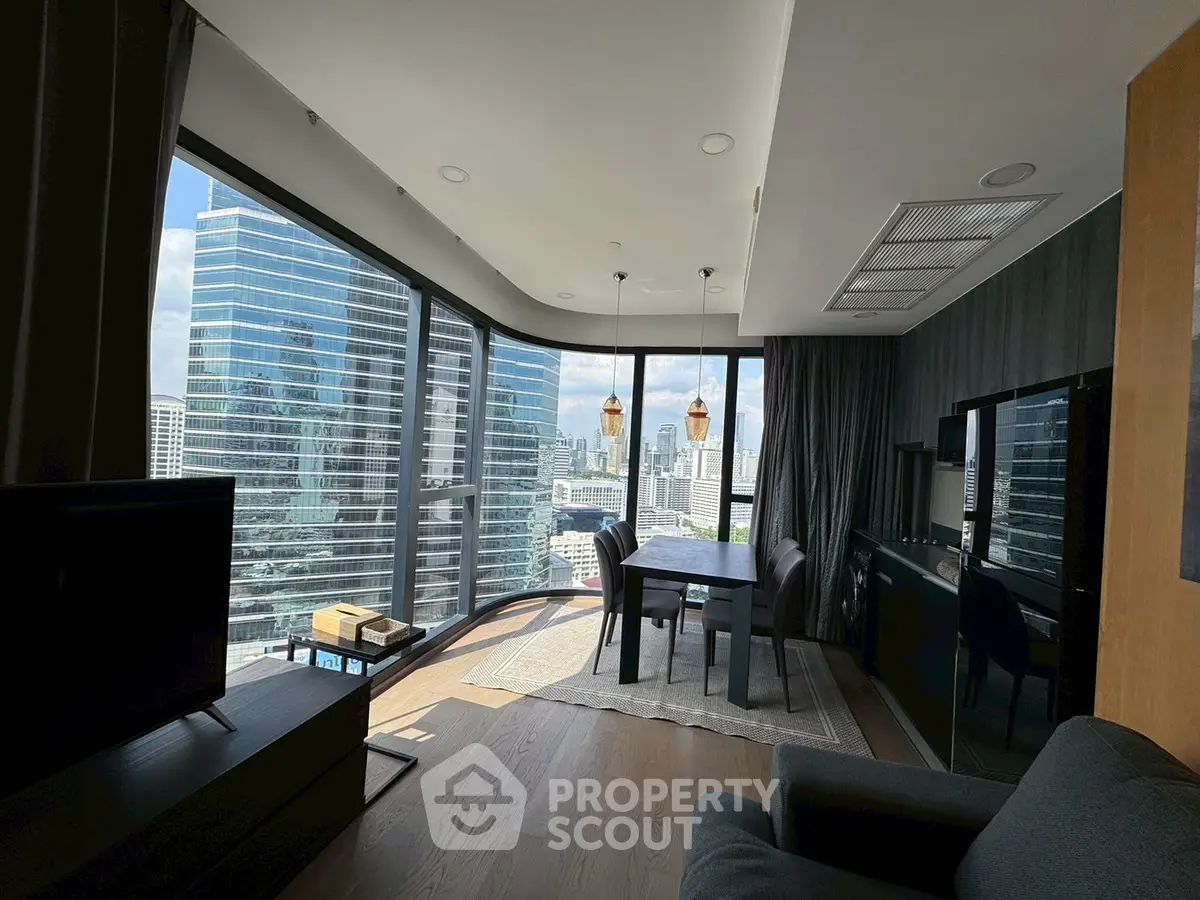 Stunning city view from modern high-rise apartment with floor-to-ceiling windows.