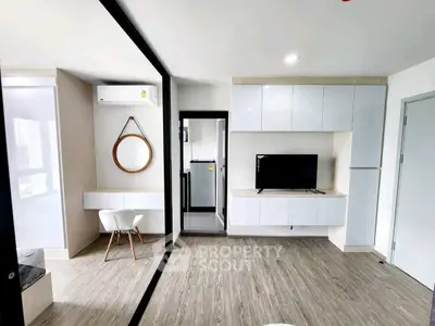 Modern living room with sleek furniture and open kitchen layout in a stylish apartment.