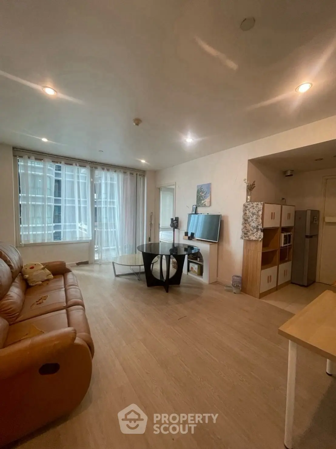 Spacious living room with modern decor and large windows for natural light.