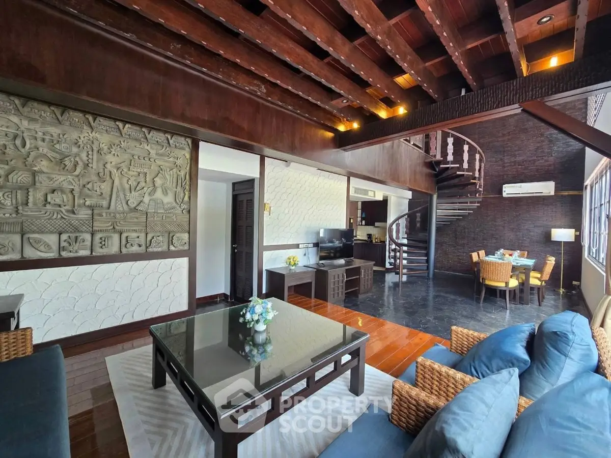 Luxurious living room with spiral staircase and elegant decor