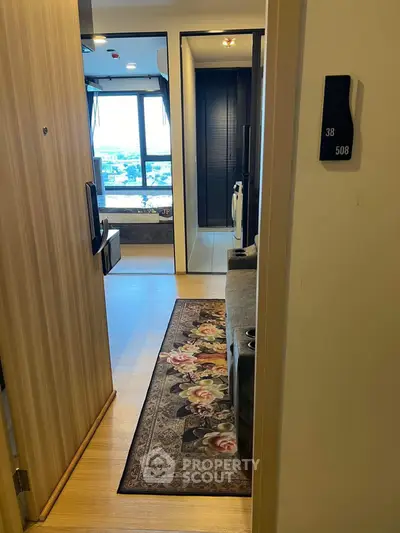 Modern apartment entrance with cozy living area and city view