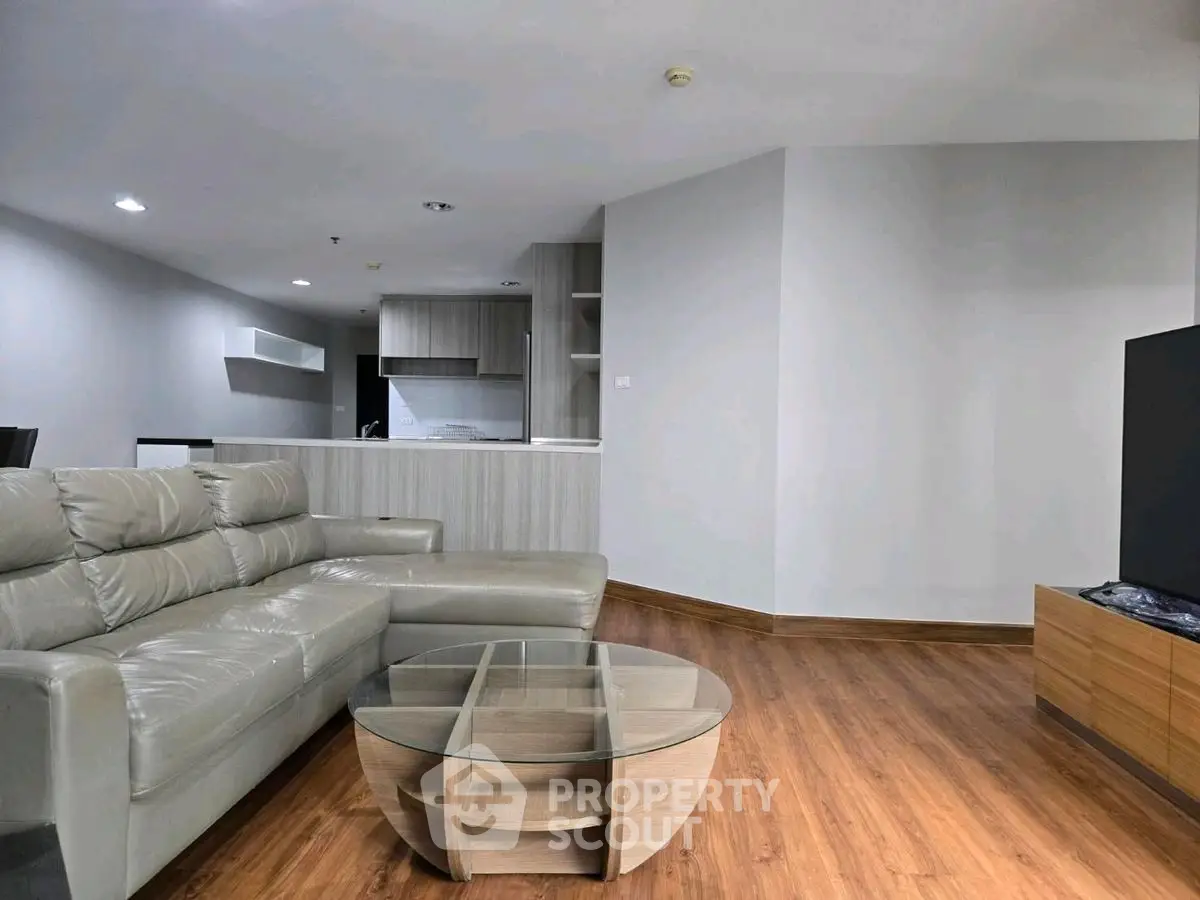 Modern living room with sleek furniture and open kitchen layout