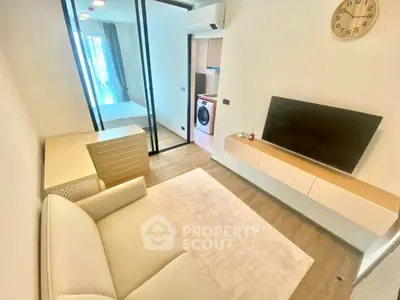 Modern living room with sleek design and integrated laundry area