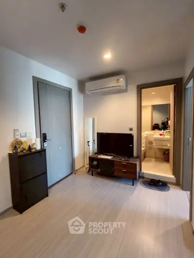 Modern living room with sleek design and compact entertainment setup