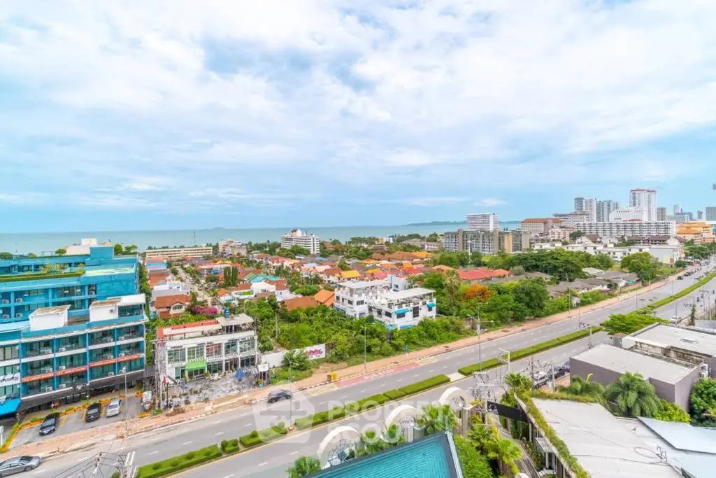 Stunning coastal cityscape view with ocean horizon and modern buildings, perfect for real estate investment.