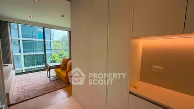 Modern living room with large windows and stylish furniture in a high-rise apartment.