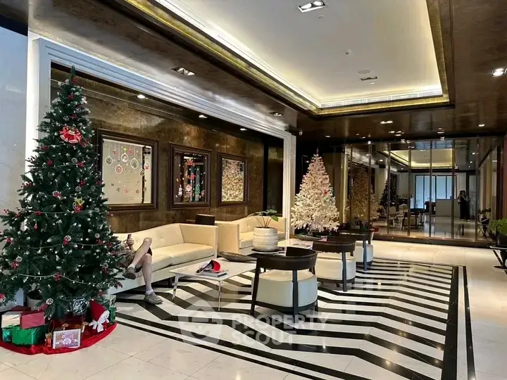 Luxurious lobby with festive decor and elegant seating area in upscale building.