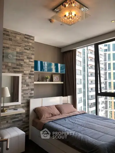 Modern bedroom with large windows and city view, featuring stylish decor and cozy bedding.