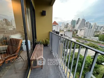 Chic urban balcony with stunning city skyline view and cozy seating area.