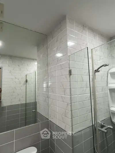 Modern bathroom with sleek tile design and glass shower enclosure