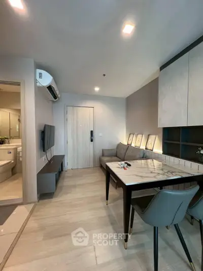 Modern living room with stylish decor and dining area in a cozy apartment.