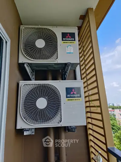 Balcony with heavy duty air conditioning units in modern apartment building.