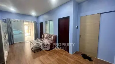 Spacious living room with modern decor and large windows for natural light.