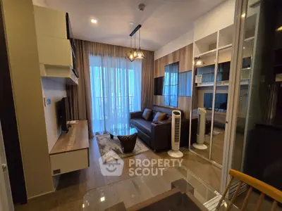 Modern living room with stylish decor, large window, and cozy seating area in a contemporary apartment.