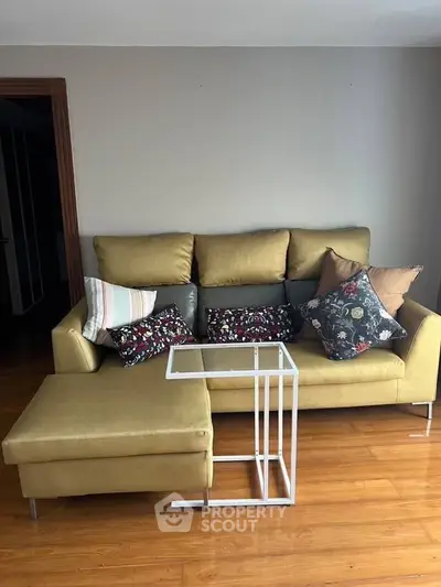 Cozy living room with stylish sofa and modern coffee table on wooden floor