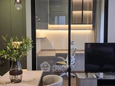 Modern living room with stylish decor and glass partitioned study area