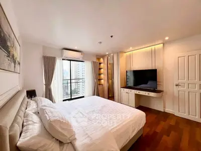 Luxurious bedroom with city view, modern furnishings, and elegant decor
