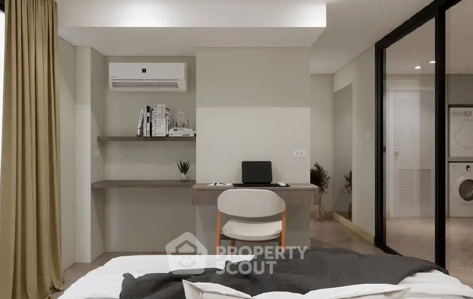 Modern bedroom with study area and in-unit laundry facilities