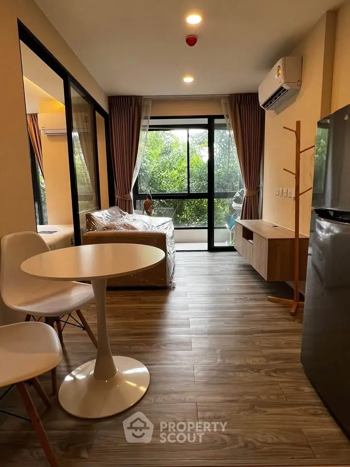 Modern living room with large windows and stylish furniture, perfect for urban living.