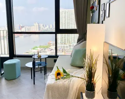 Stunning living room with panoramic city and river views, modern decor, and cozy seating area.
