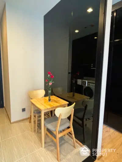 Cozy dining nook with wooden table and chairs in modern apartment