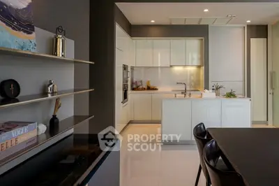 Modern kitchen with sleek cabinetry and island, featuring open layout and stylish decor.