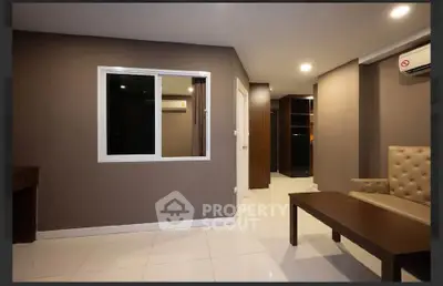 Modern living room with sleek furniture and neutral tones, featuring a cozy ambiance and stylish design.