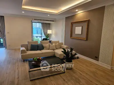 Spacious modern living room with elegant decor and city view, featuring a cozy sofa and stylish coffee table.