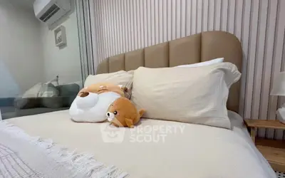 Cozy bedroom with plush pillows and modern decor, perfect for relaxation.