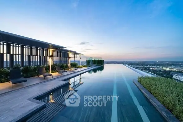 Luxurious rooftop infinity pool with stunning panoramic views at sunset.