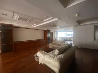 Spacious living room with elegant wooden flooring and modern furniture
