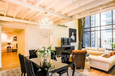 Luxurious living room with elegant chandelier and modern decor in high-rise apartment