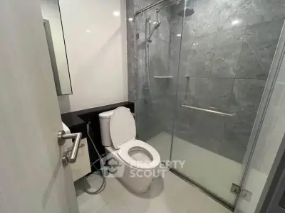 Modern bathroom with glass shower and sleek fixtures