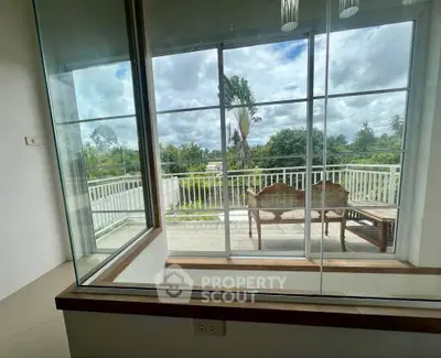 Spacious balcony with scenic view and elegant outdoor seating.