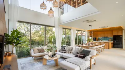 Luxurious open-plan living room with modern decor and garden view
