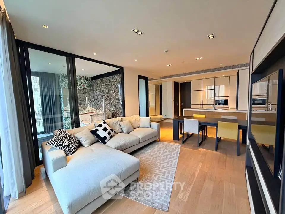 Luxurious open-plan living room with modern kitchen and spacious balcony view.