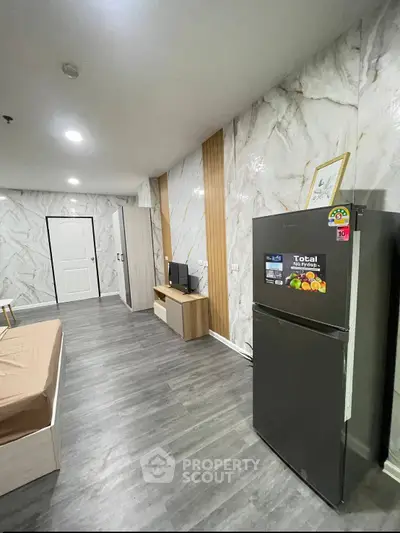 Modern studio apartment with sleek design and marble accents, featuring a spacious layout and contemporary furnishings.