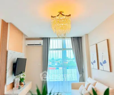 Elegant living room with chandelier, modern decor, and large window view.