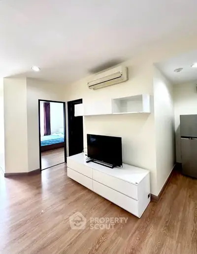 Modern living room with sleek furniture and air conditioning in a stylish apartment.