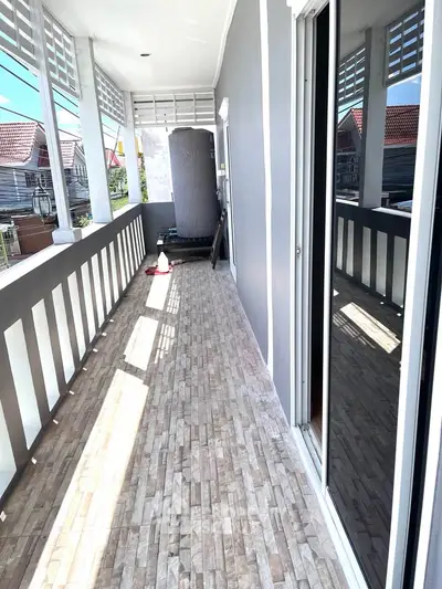 Spacious balcony with tiled flooring and modern railing, perfect for relaxation and outdoor enjoyment.