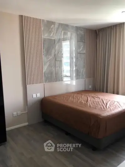 Modern bedroom with stylish wall paneling and natural light